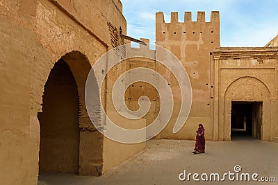Morocco. Taroudant. A woman in a chador in front of the city walls Editorial Stock Photo