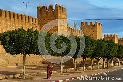 Morocco. Taroudant. A woman walking front of the city walls Editorial Stock Photo