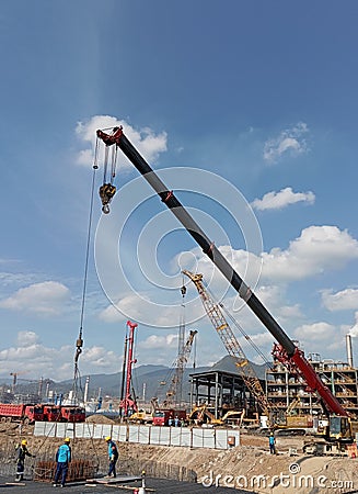 crane operator unloads steel at the project site Editorial Stock Photo
