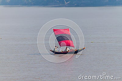 MORRELGANJ, BANGLADESH - NOVEMBER 19, 2016: Small sail boat on Pangunchi river near Morrelganj village, Banglade Editorial Stock Photo