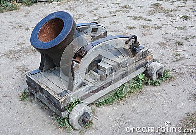 A mortar is a device that fires projectiles at low velocities and short ranges. Stock Photo
