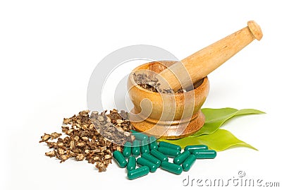 Mortar and pestle with herb capsules Stock Photo