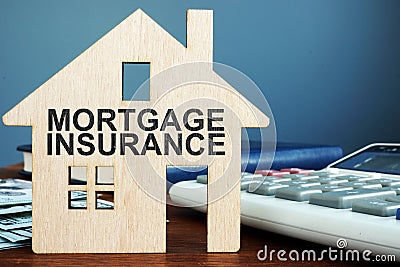 Mortgage insurance. Wooden home, money and calculator Stock Photo