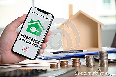 Mortgage Loan approval on mobile phone in a house contract form with approved home ownership Stock Photo