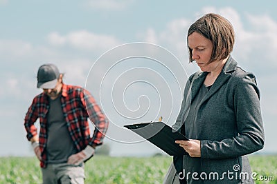 Mortgage loan officer assisting farmer in financial allowance application process Stock Photo