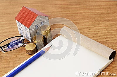 Mortgage loans concept with pencil and notepad with paper house Stock Photo