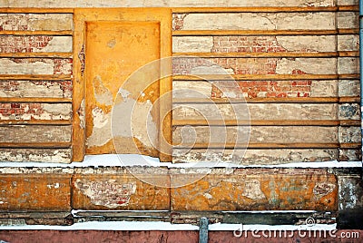 Mortgaged window of the old brick building with cracked plaster, winter snowy street Stock Photo