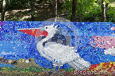 Mosaic with a dalmatian pelican or pelecanus crispus figure made of waste plastic caps Editorial Stock Photo