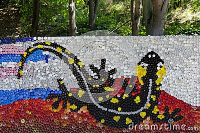 Mosaic with a fire salamander or salamandra figure made of waste plastic caps Editorial Stock Photo