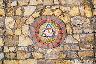 Mosaic star of David on stone wall. Stock Photo