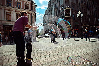 Moscow. Arbat street. Child and bubble blower Editorial Stock Photo