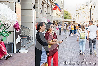 Two adult asian women taking a selfie using smartphone Editorial Stock Photo