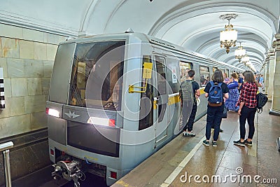 MOSCOW, AUG, 22, 2017: Modern subway passenger train at metro station and train waiting people on railway station ptatform. Perspe Editorial Stock Photo