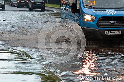 Cars after heavy rain driving in water flood, fixed route taxi-bus closeup Editorial Stock Photo