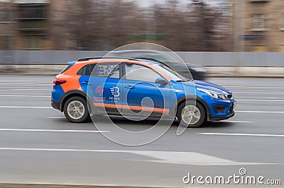 Moscow carsharing Belka Car. Kia Rio hatchback rushes along the street on high speed Editorial Stock Photo