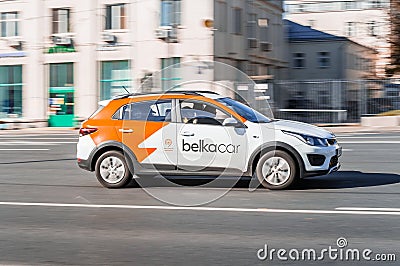 Moscow carsharing company Belka Car. Kia Rio hatchback driving along the street on high speed Editorial Stock Photo
