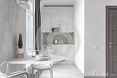 White Scandinavian modern living room with dining area and small kitchen 0063 Editorial Stock Photo