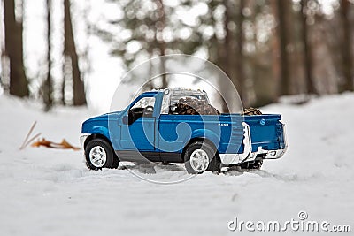 Moscow. December 2018. Blue Pickup truck Ford F350 in snow forest. Fir cones in the back of a toy car body. Winter road Editorial Stock Photo