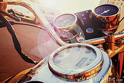 Fragment of old fashioned motorcycle with handlebar and dashboard in sun glare, tinted Editorial Stock Photo