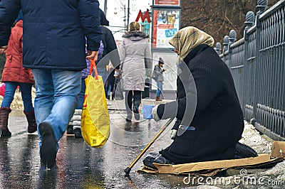 Moscow-January 31, 2016. Woman beggar with walking stick asking for money on Moscow street in winter Editorial Stock Photo