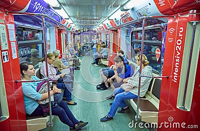 MOSCOW, MAY, 13, 2018: Different people traveling in russian modern subway passenger train. Mass transit metro electric transport. Editorial Stock Photo
