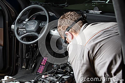 Moscow. November 2018. A mechanic repairs an Audi ... Repairing wiring, gearboxes, disassembled interior premium crossover. Editorial Stock Photo