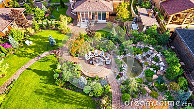Landscape design with patio at residential house taken from above. Beautiful landscaping in home garden in summer Editorial Stock Photo