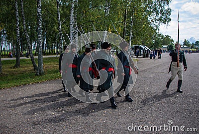 MOSCOW REGION - SEPTEMBER 06: Unknown soldiers walking at Borodino historical reenactment battle at its 203 anniversary. Editorial Stock Photo