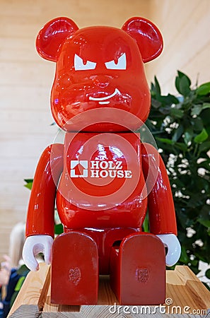 Moscow, Russia - April 21, 2023: Branded toy in the form of a red plastic bear with the inscription the name of the construction Editorial Stock Photo