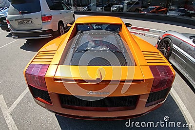 Moscow, Russia - April 14, 2019: Bright orange Lamborghini Gallardo with carbon hood and other parts parked on the street near Editorial Stock Photo