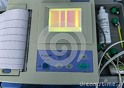 Moscow, Russia, April 2020: Close-up of a working electrocardiograph with the monitor turned on and printing a sheet with a Editorial Stock Photo