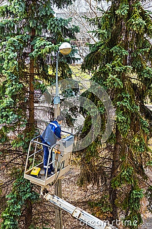 Moscow, Russia - April 10, 2024: Electrician repairs street lighting Editorial Stock Photo