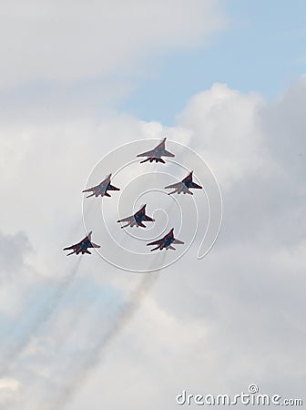 Performance of the Swifts aerobatic team on multi-purpose highly maneuverable MiG-29 fighters over the Myachkovo airfield Editorial Stock Photo