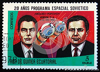 MOSCOW, RUSSIA - APRIL 2, 2017: A stamp printed in Guinea Equatorial shows Vostok 3 and 4 spaceship, 1962, and portraits Editorial Stock Photo