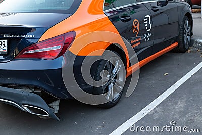 A CLA 200 car Mercedes Benz from car sharing company `Belka car` on toll parking. Rear bumper fell off after a traffic accident. Editorial Stock Photo