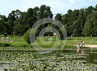 People are bathing dogs in the pond of the park `Kuzminki-Lublino` Editorial Stock Photo