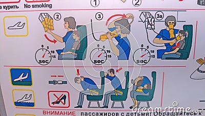 Moscow, Russia, August 5, 2018 Safety instruction aboard the Pobeda airplane. Emergency Landing and Evacuation on Water sign on Editorial Stock Photo