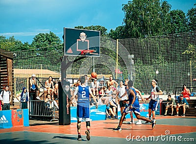 Moscow, Russia - August 4, 2018: Team playing basketball in the Gorky Park in summer. Basketball player throws the ball Editorial Stock Photo