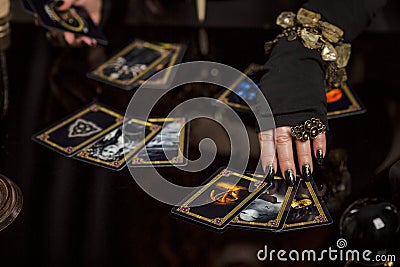 Moscow, Russia, 06/01/2019: Beautiful aged redheaded woman fortune teller performs a magical ritual Stock Photo