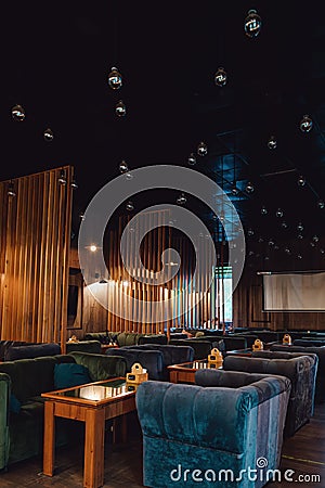 Moscow. Russia. Circa 2022. New designer cafe in loft style. Night photos of the institution. Natural wood tables and Editorial Stock Photo