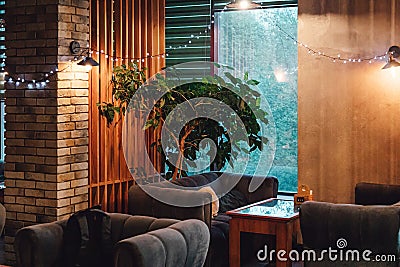 Moscow. Russia. Circa 2022. New designer cafe in loft style. Night photos of the institution. Natural wood tables and Editorial Stock Photo