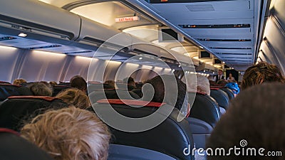 Moscow, Russia December 18, 2019: The rear view of the many people on the plane. Interior of airplane with passengers Editorial Stock Photo