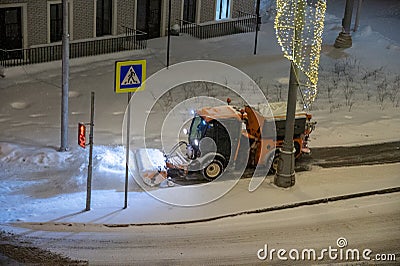 Moscow, Russia - December 7, 2022: Snowplow clearing snow from the street. Multihog mxc 100 Bucher Gmeiner Husky BlueDynamics Editorial Stock Photo