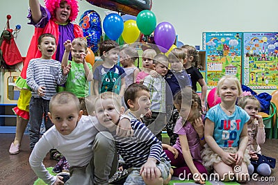 Portrait of a group kids sitting on the carpet. Editorial Stock Photo