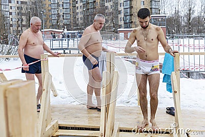 Moscow, Russia, 01/19/2019: Epiphany bathing in the ice hole in winter. Undressed people in ice water Editorial Stock Photo