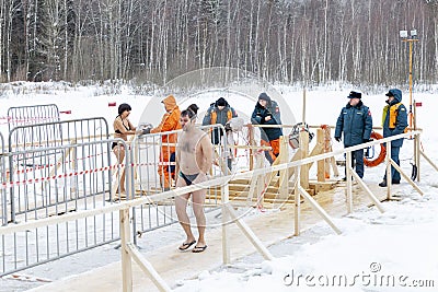 Moscow, Russia, 01/19/2019: Epiphany bathing in the ice hole in winter. Undressed people in ice water Editorial Stock Photo