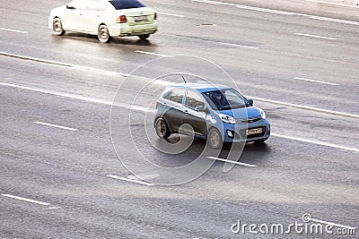 Aerial front side view rolling shot with blue car Kia Picanto in motion Editorial Stock Photo
