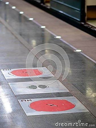 Moscow, Russia - February 8, 2020: Fire hatches at the Moscow metro station. Red covers on the floor of the platform at the wells Editorial Stock Photo