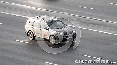Gray Nissan X-Trail first generation T30 car moving on the street. Compliance with speed limits on road concept Editorial Stock Photo