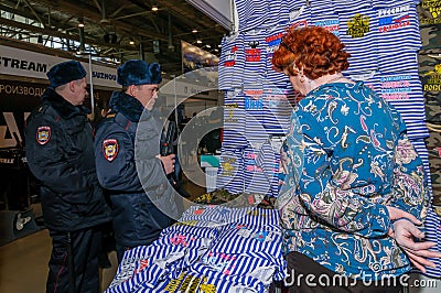 Moscow, Russia - February 25, 2017: Two russian policemen visiting the stand with funny military-patriotic t-shirts Editorial Stock Photo